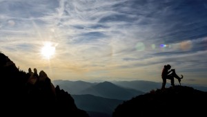 girl and dog on top of the mountain